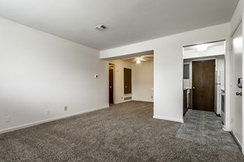 A spacious room with a carpeted floor and white walls at Bay Pointe Apartments, Lafayette, IN, 47909